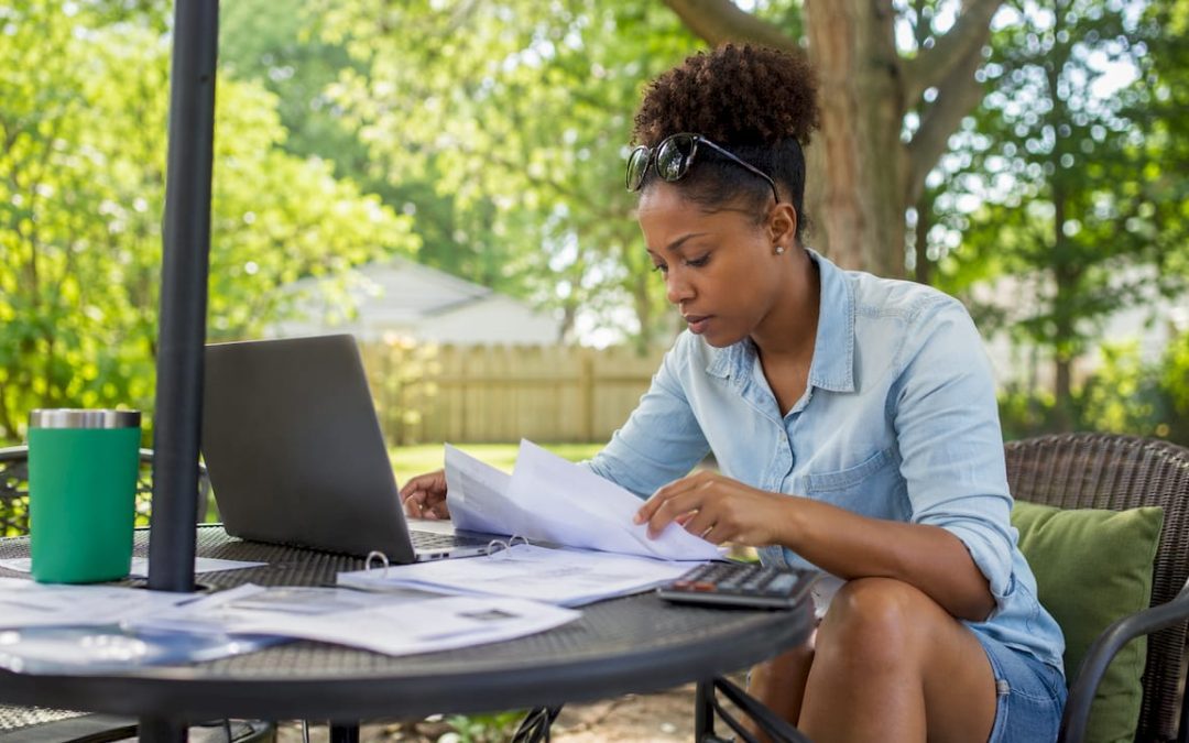 Woman reviewing home inspection costs at kitchen table