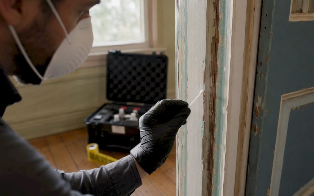 Inspector testing painted windowsill for lead