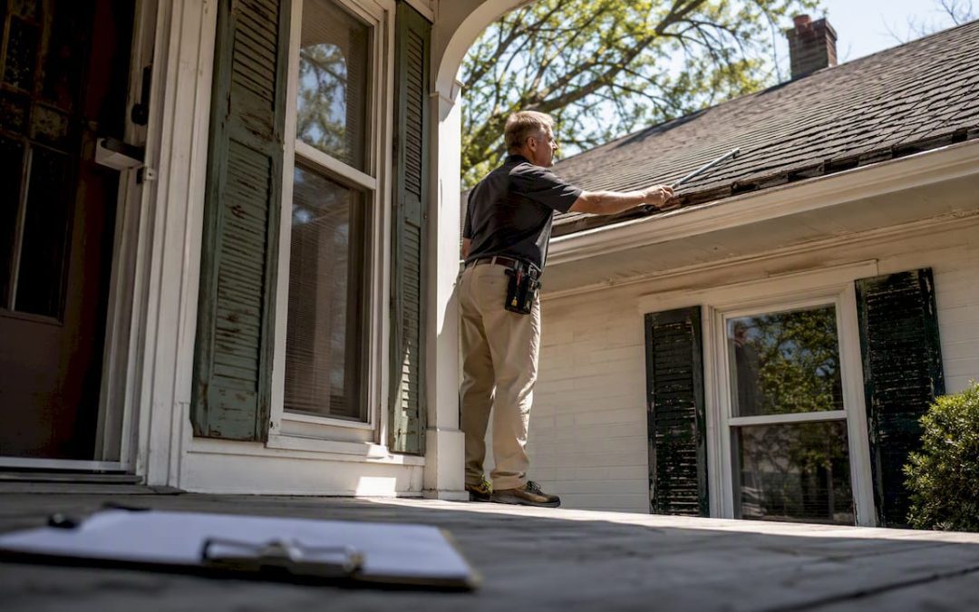 Inspector examining affordable home exterior