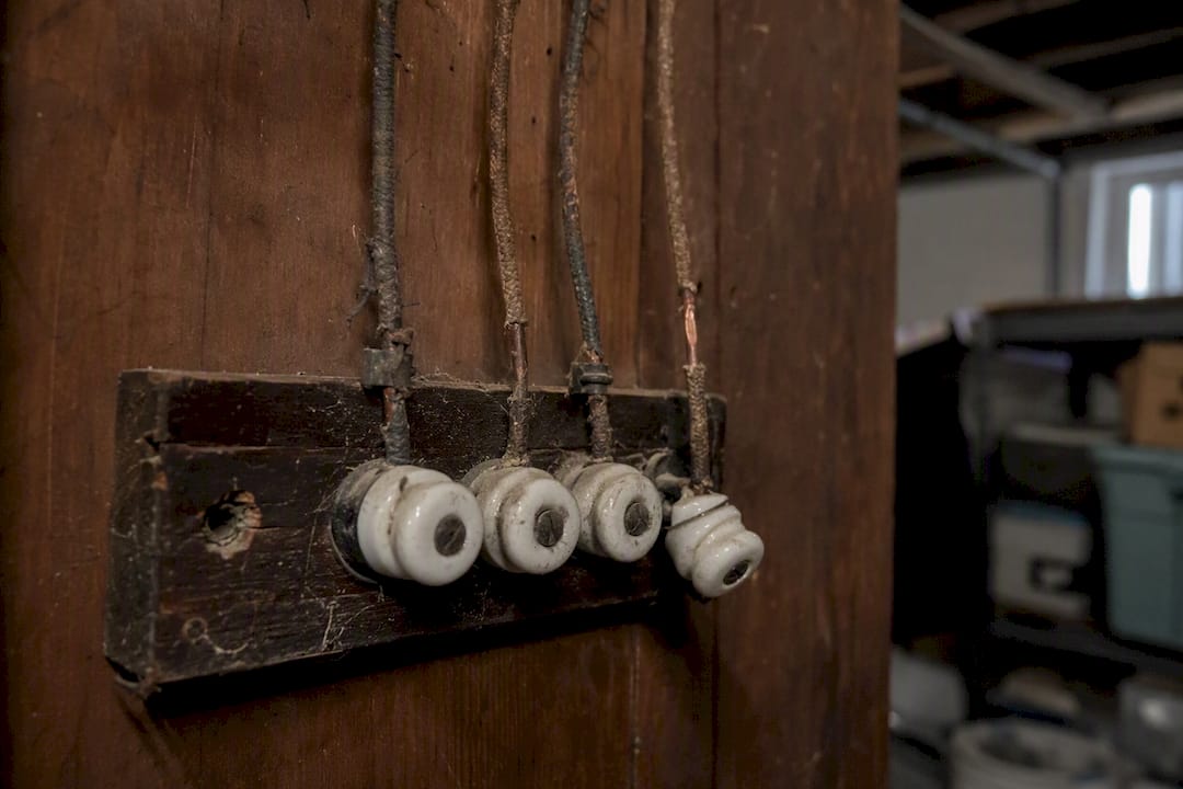 Close-up of degraded knob-and-tube wiring damage