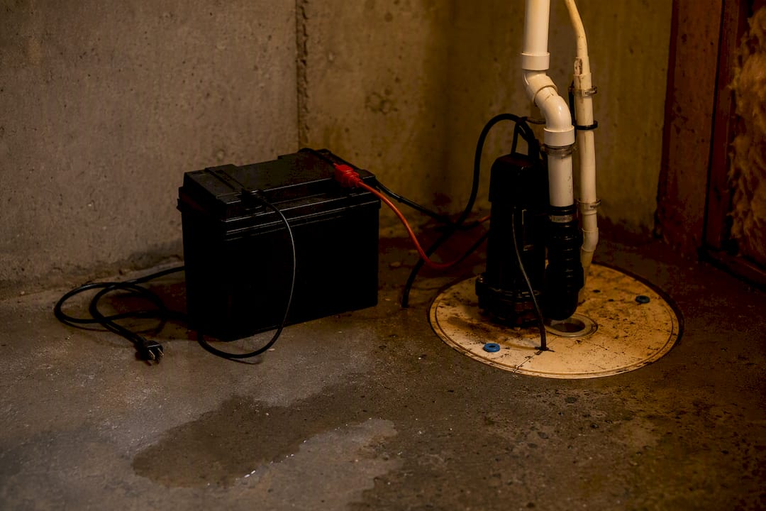 Backup battery next to sump pump in basement