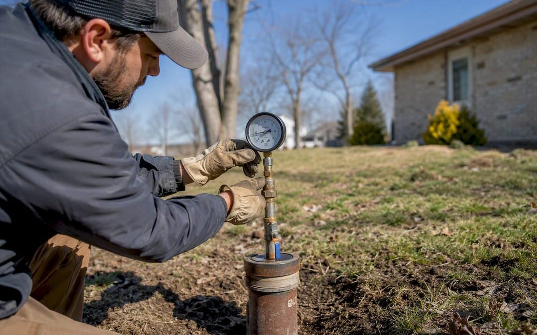 Inspector testing water well at residential property