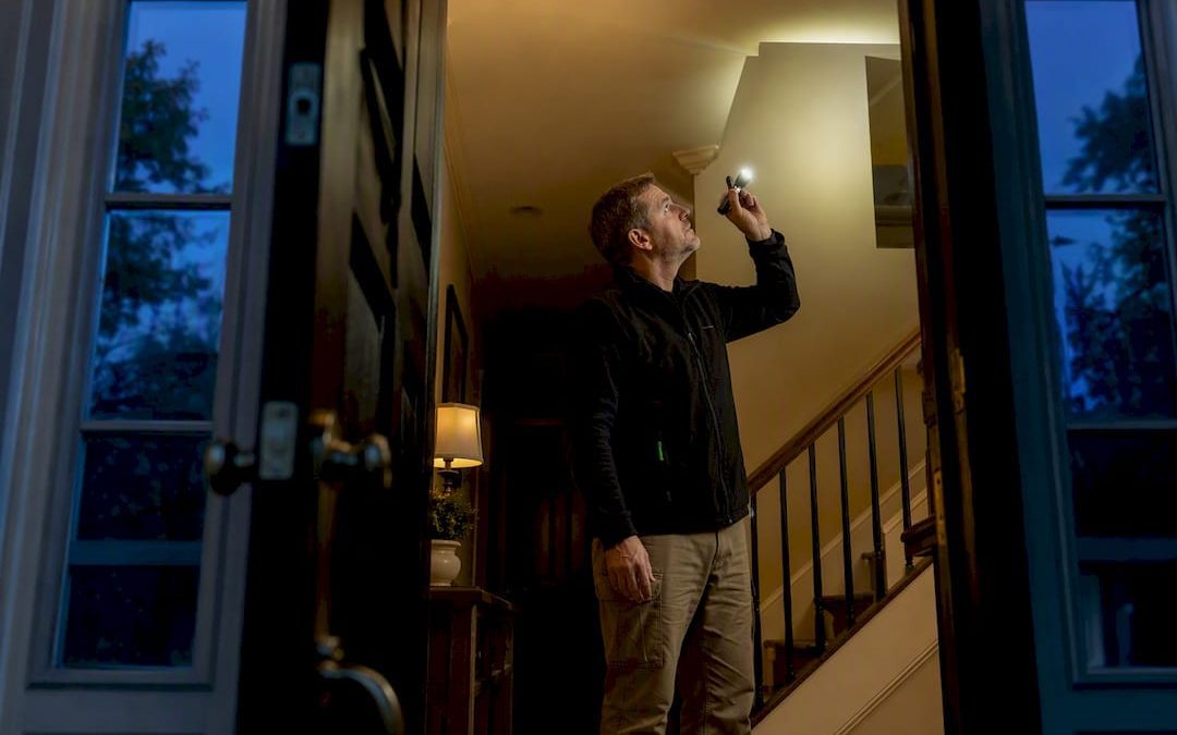 Inspector examining home interior after dark