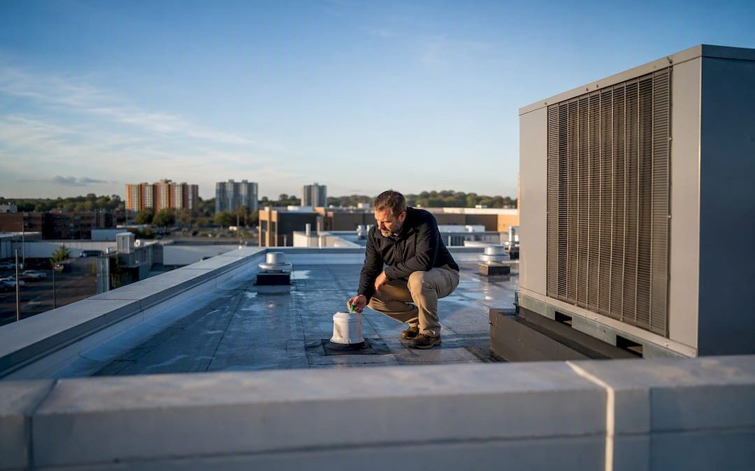 Inspector examining commercial rooftop equipment