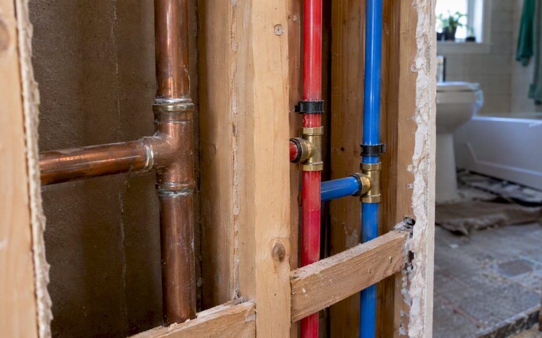 Copper and PEX pipes in an open wall